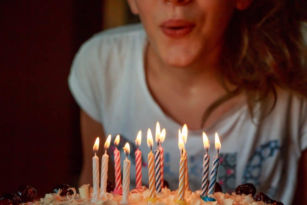  a girl blowing candle