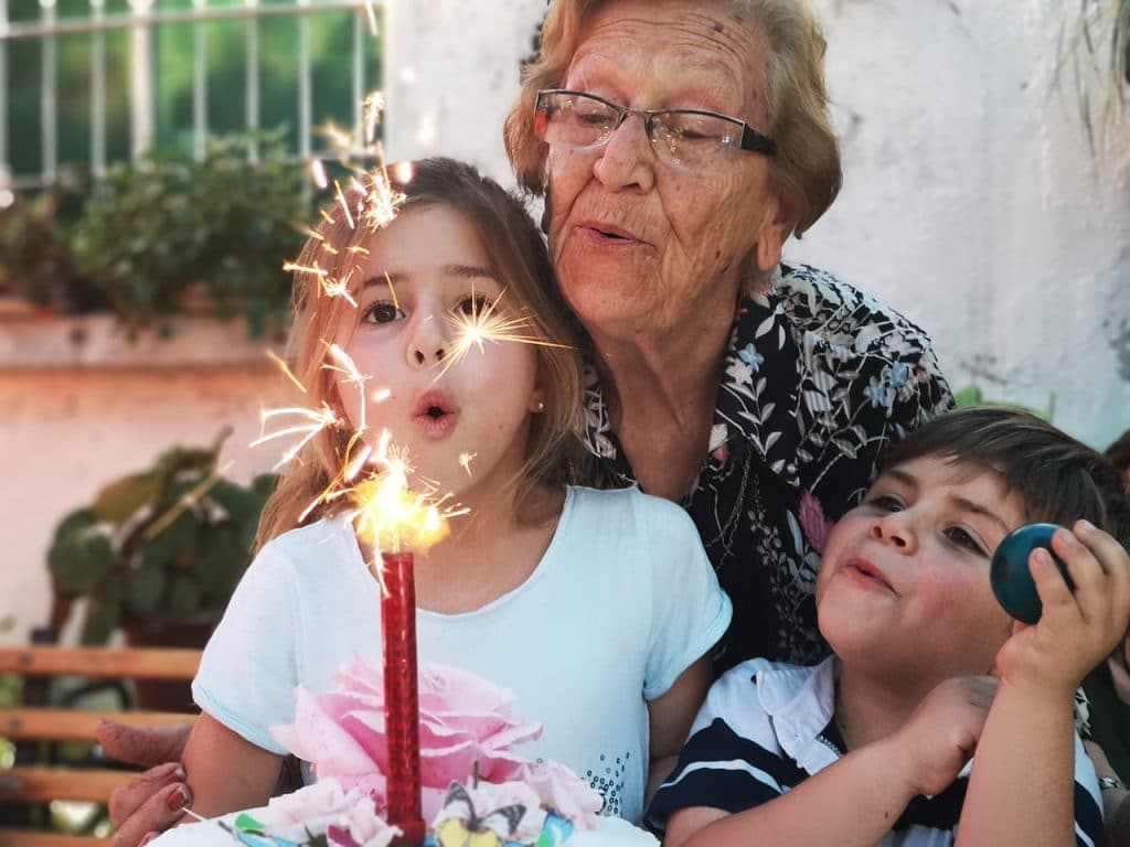 grandmother blowing birthday candle