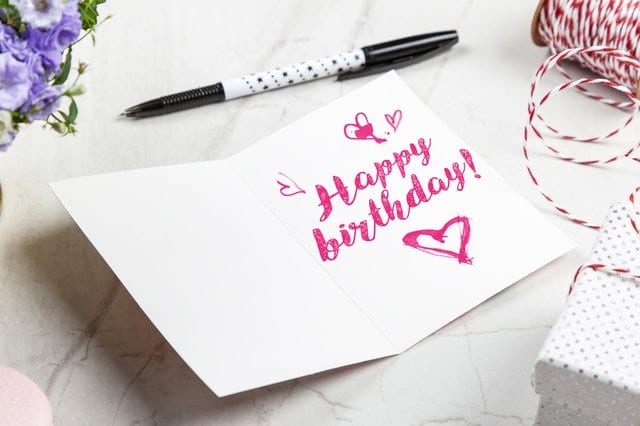 adult birthday party ideas open-birthday-greeting-card-near-pen