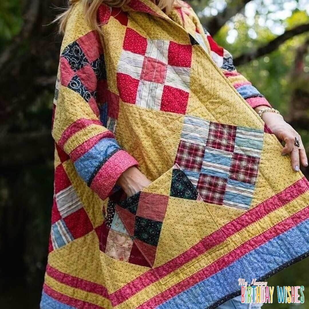 Coat Patchwork Quilt in red, blue and yellow shades of cloth.