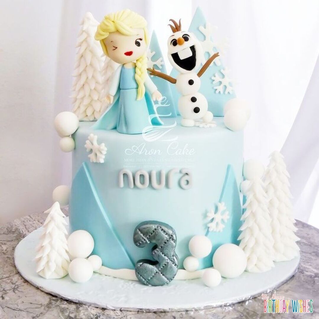 Cute Elsa and Olaf Cartoon Cake - White Pine trees fondant with snow balls design.