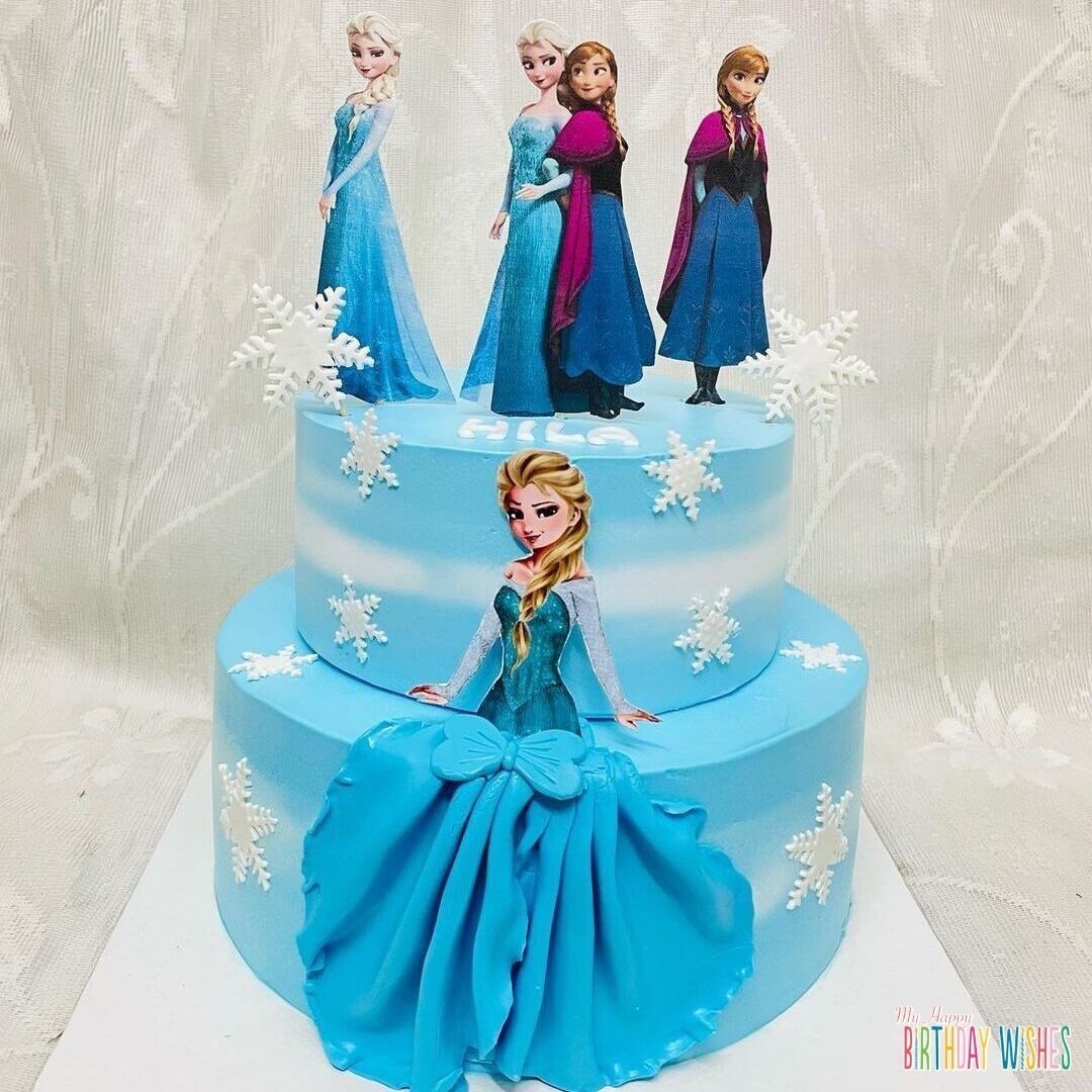Elsa and Anna Topper Cake with blended white blue icing with snow flakes.