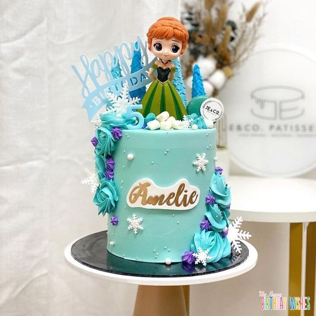 Frozen Anna Theme Tall Cake with pine trees fondant and snowy flakes on top.