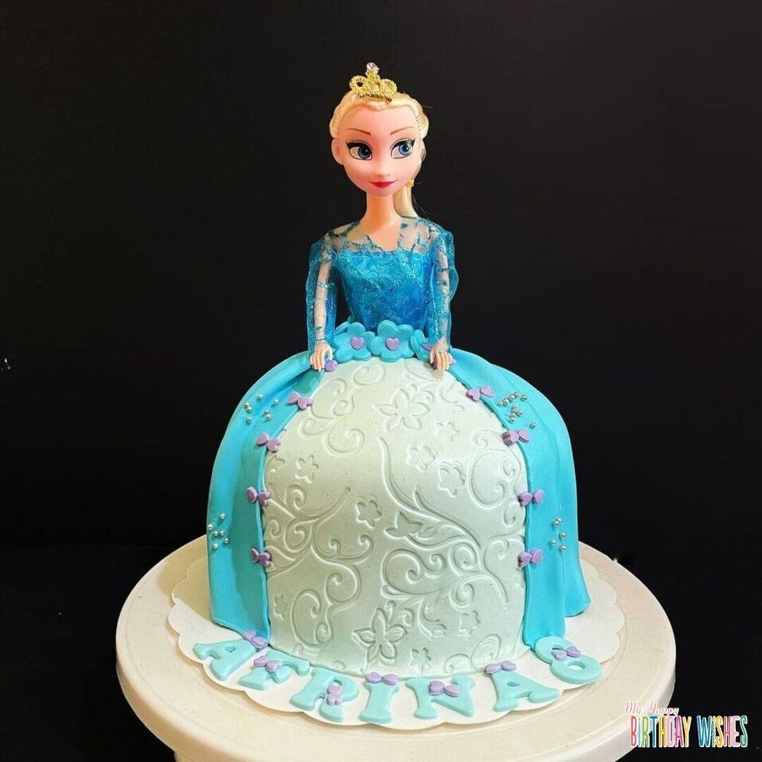 Frozen Elsa Doll Cake with small purple ribbon on the gown of Elsa.