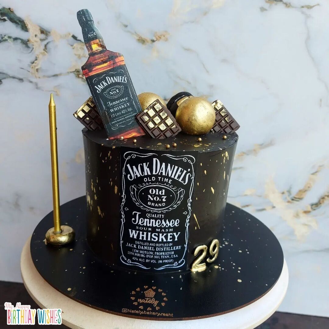 Jack Daniel's Cake in black, gold theme with bottle topper.