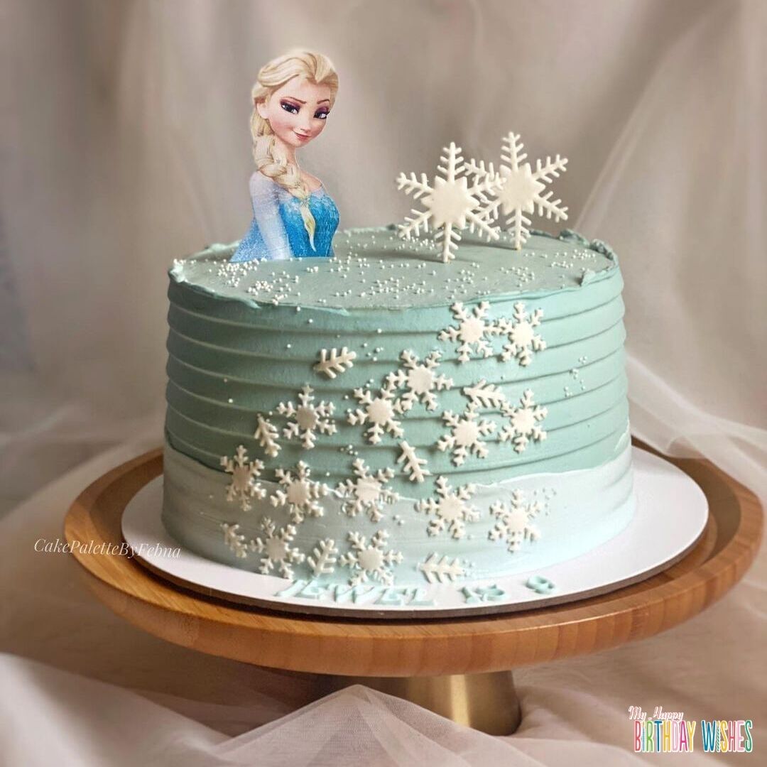 Simple Snow Flake Elsa Cake in sage green with elsa topper.