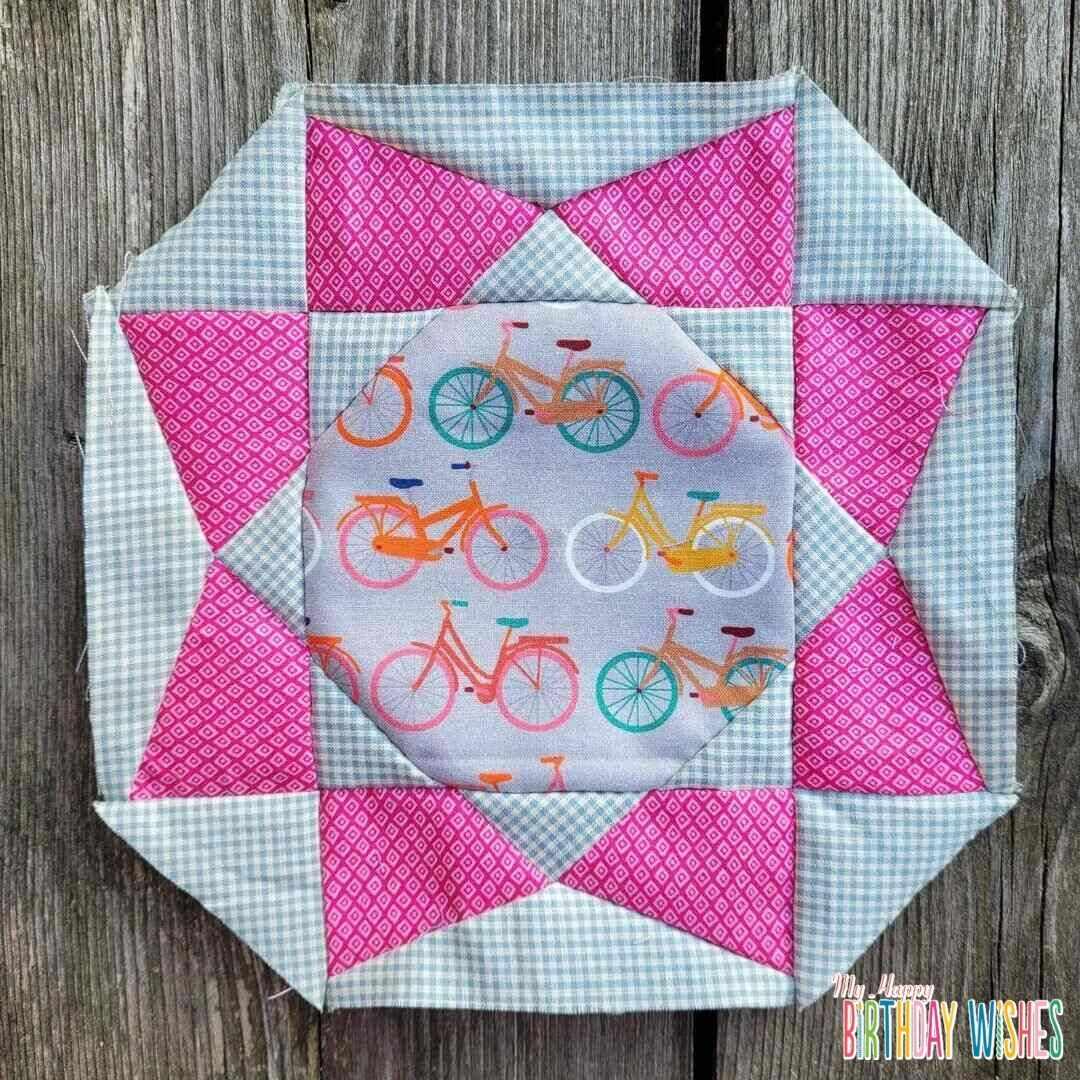Whimsy Patchwork Quilt in plaid and pink shade with bicycle designs.