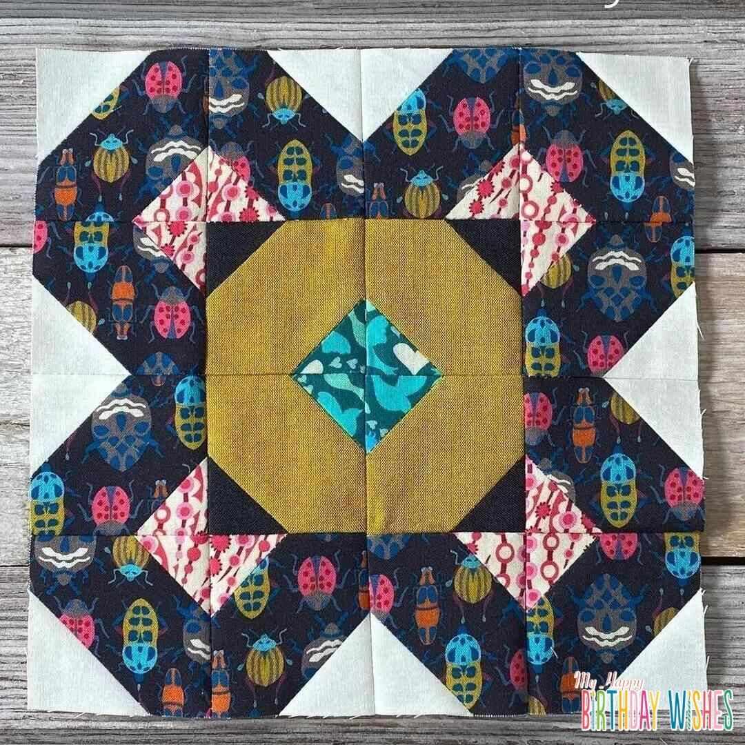 X Insects Patchwork Quilt in dark colors.