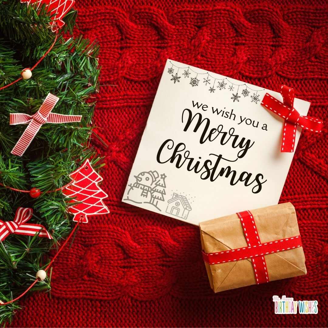 christmas card design written in a white paper with gift and ribbons