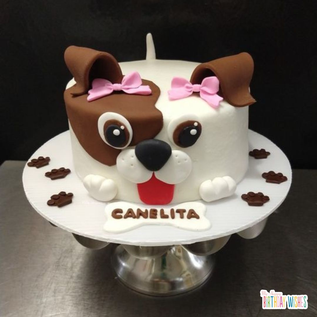 dog face shape birthday cake with ribbons in ear and paw design