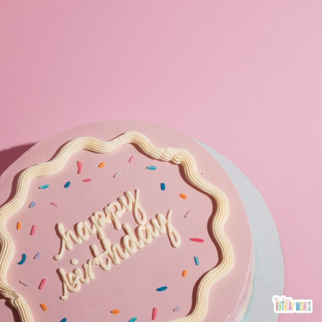 pink cake with happy birthday lettering