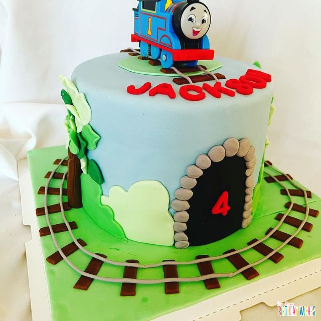 a cake with train and train tracks