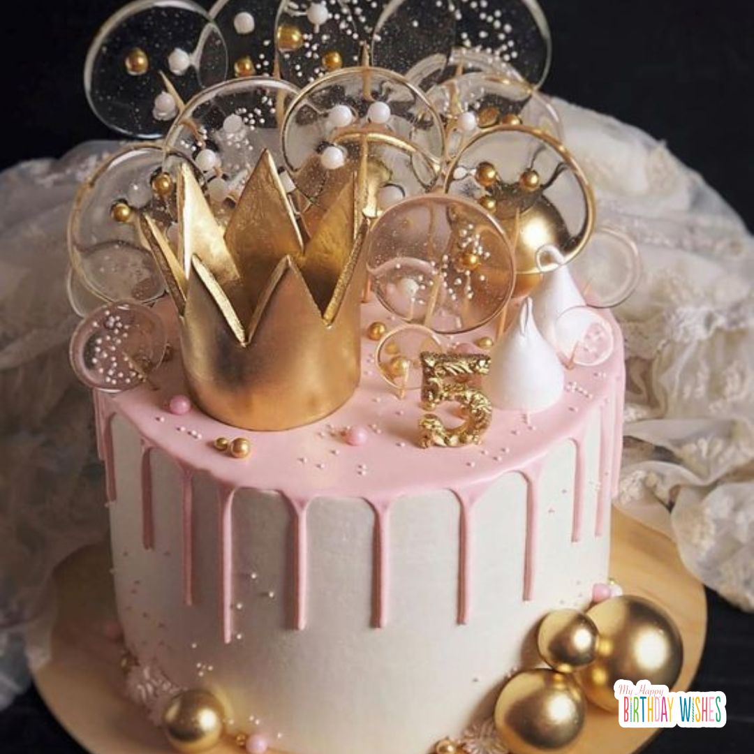 birthday cake with gold crown and glass